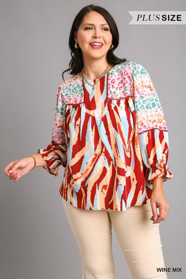 Umgee Mixed Print Top with 3/4 Sleeves and Lace Trim. Features Open Split Back Details with Button Closure