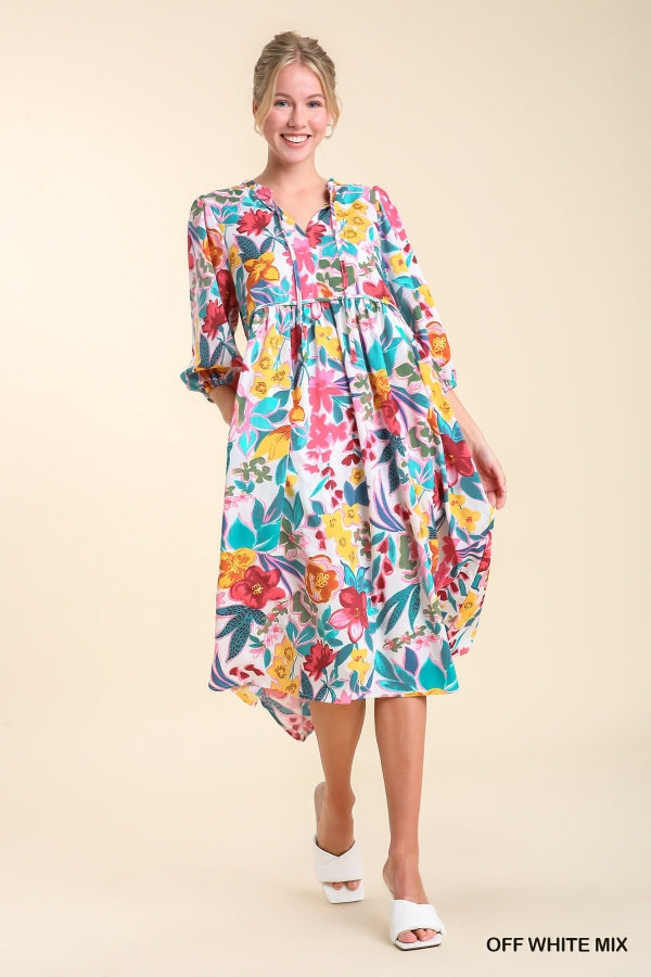 Umgee Floral Print V- Notch Peasant Dress with 3/4 Puff Sleeves, Neck Tie Detail, Side Pockets and Ruffle Trim Along Neckline No Lining