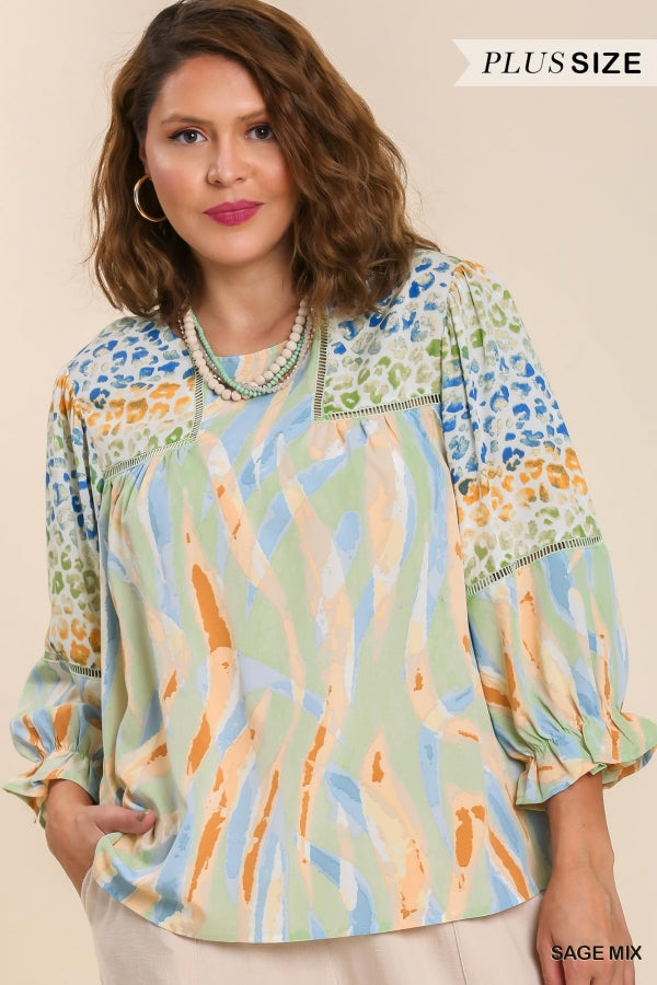 Umgee Mixed Print Top with 3/4 Sleeves and Lace Trim. Features Open Split Back Details with Button Closure