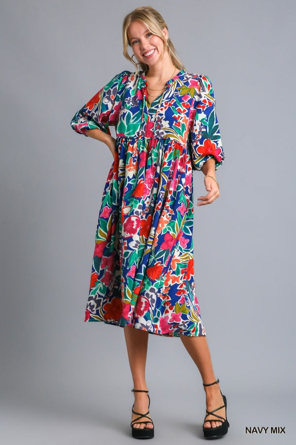 Umgee Floral Print V- Notch Peasant Dress with 3/4 Puff Sleeves, Neck Tie Detail, Side Pockets and Ruffle Trim Along Neckline No Lining