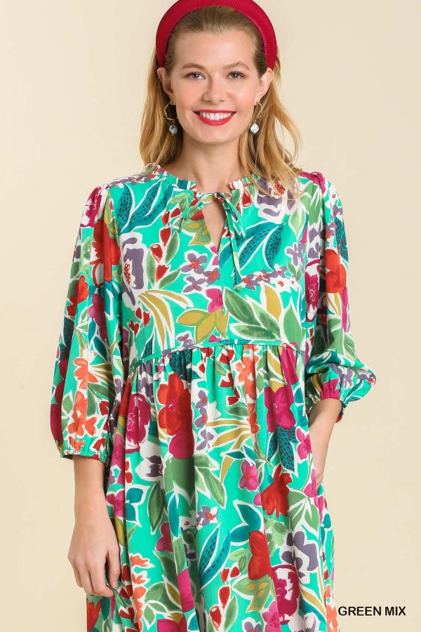 Umgee Floral Print V- Notch Peasant Dress with 3/4 Puff Sleeves, Neck Tie Detail, Side Pockets and Ruffle Trim Along Neckline No Lining